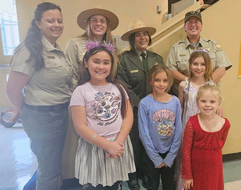 Young girls pose with Women in Rec Park Ranger panelists