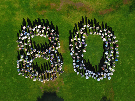 Aerial photo of Parks and Recreation staff forming the number 80 in honor of the 80th anniversary
