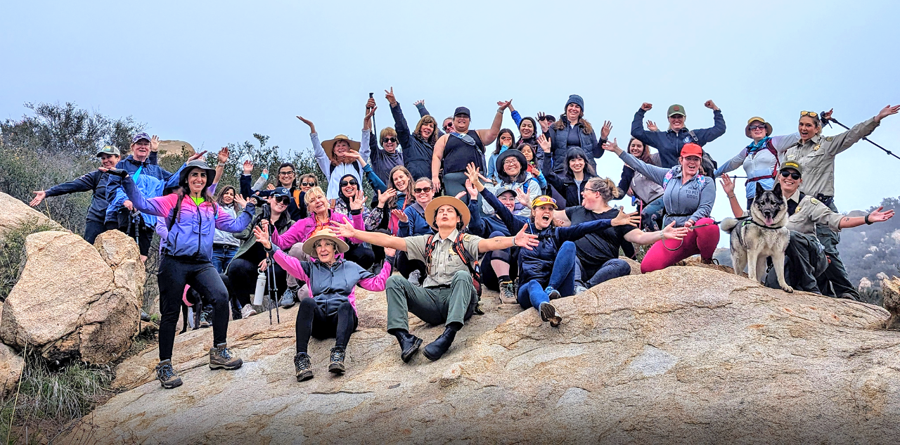 Women in the Wild - Group of women celebrating a hike to the top